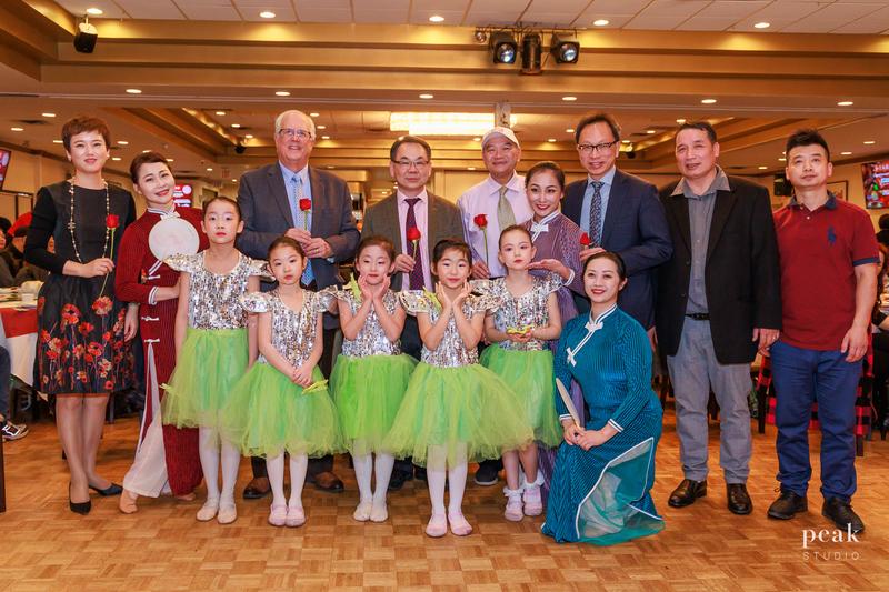 YiYe students in green tutus with teachers and guests at a community gala
